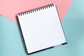 Top view of open notebook with clean sheet. Template for message. Empty spiral sketchbook with white paper on pastel Royalty Free Stock Photo