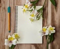 Top view of open notebook, marker and bouquet of alstroemeria flowers. Background workplace Royalty Free Stock Photo