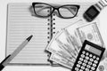 Top view of an open notebook with a pen or pencil, glasses, men`s watch, cash, calculator on a white background Royalty Free Stock Photo