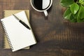 Top view of open school notebook with blank pages, Pen, Plant and Coffee cup on wooden table background. Business, office or educa Royalty Free Stock Photo