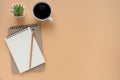 Top view of open school notebook with blank pages and pencil with coffee cup on brown background. Royalty Free Stock Photo