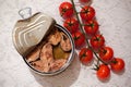 Top view of an open tin can of fish with cherry tomatoes Royalty Free Stock Photo