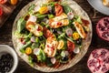 Top view of an open top vegetarian tortilla with salad, raddish, chery tomatoes, olives, pomegranate and grilled haloumi cheese Royalty Free Stock Photo