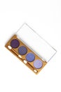 Top view of opened case with different shaded purple cosmetic eye shadows Royalty Free Stock Photo