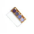 Top view of opened container with different shaded purple cosmetic eye shadows Royalty Free Stock Photo