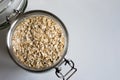 Top view of a jar filled with rolled oats and a white background with copy space Royalty Free Stock Photo