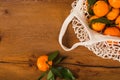 Top view of orange clementines in reusable mesh bag