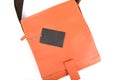 Top view,Orange leather bag with black price tag on white background