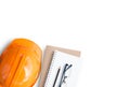 Top view with orange safety engineer helmet and blank notebook Royalty Free Stock Photo