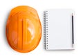 Top view with orange safety engineer helmet and blank notebook o