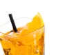 Top of view of orange slice on top of the yellow cocktail with ice cubes and straw on white background Royalty Free Stock Photo