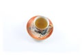 Top view of orange and white Japanese dragon teacup and saucer with tea
