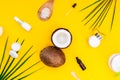 Top view organic natural cosmetics for face and body skincare with coconut oil on yellow background. Fresh coconuts and Royalty Free Stock Photo