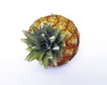 Top view of an organic pineapple on white background. Close up of natural ananas fruit and its crown-shaped leaves. Healthy food Royalty Free Stock Photo