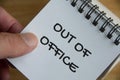 Top view of Out Of Office notification text on white notepad. Business concept Royalty Free Stock Photo