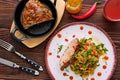 Top view of oven-baked meat with braised cabbage and zucchini and spicy sauce