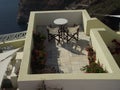 Top view over a table and two chairs, looking out to the sea in Santorini, Greece