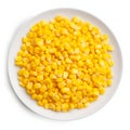 Top view over a white plate full of yellow corn kernels. Corn as a dish of thanksgiving for the harvest, a picture on a white