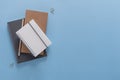 Top view over the working desk with notebook, pencil and paper clips. Copy space for text. Flat lay of a workplace on blue backgro Royalty Free Stock Photo