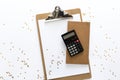 Top view over the working desk with paper, notebook and calculator at the top with randomly droped golden stars. Copy space for te Royalty Free Stock Photo