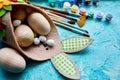 Top view pack of eggs with brush, paint and decorative elements on blue background. Copy space, Happy Easter, DIY,
