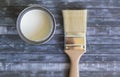 Top view of paint brush and can of white paint on blue background Royalty Free Stock Photo