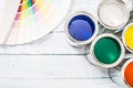 Top of view paint cans brushes and color palette on table Royalty Free Stock Photo