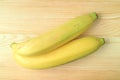 Top View of a Pair of Bright Yellow Ripe Bananas on Wooden Table