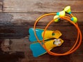 Top view of pair of colorful flippers and toy swimming aid for kid diving practice on wooden background with copy space Royalty Free Stock Photo