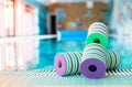 Top view - pair of dumbbells for aqua aerobics float on the surface of water in swimming pool on a warm summer day