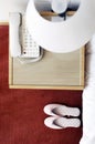 Top view of a pair of pink shoes beside the bed. Conceptual image shot