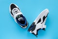 Pair of white and black sporty shoes for kid on blue background Royalty Free Stock Photo