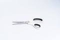 Top view of a pair of white color plastic open scissors