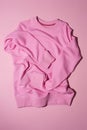 Top view of pale pink pastel sport blank sweatshirt lying vertically isolated on light pink background Royalty Free Stock Photo
