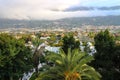 Top view of the palm trees, the city of Puerto de La Cruz, the valley and the Teide volcano in the clouds.Tenerife. Royalty Free Stock Photo