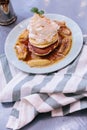 Top view of Pancakes with caramel-banana syrup topping with whip cream and mint leaves. In blue plate over fabric. Royalty Free Stock Photo