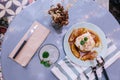 Top view of Pancakes with caramel-banana syrup topping with whip cream and mint leaves. With spoon, fork and knife, in blue plate. Royalty Free Stock Photo