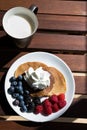 top view of pancakes with cream, blueberries and grapes with a g Royalty Free Stock Photo