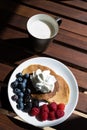 top view of pancakes with cream, blueberries and grapes with a g Royalty Free Stock Photo