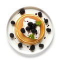 Top view of pancakes with whipped cream and blackberries.