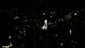 Top view of panorama of modern city at night. Stock footage. Glowing night city with modern buildings and high-rises