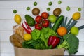 Paper bag of different health food on white wooden background. Top view Royalty Free Stock Photo