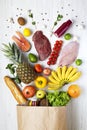 Top view, paper bag of health food on a white wooden background. From above, flat lay.