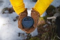 Top view paper cup with a black lid in the hands of a woman in mittens