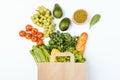 Top view paper grocery shopping bag with healthy food fresh vegetables