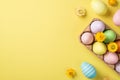 Top view of paper half carton with multicolored Easter eggs and flowers and three pastel eggs and bright flowers on the isolated