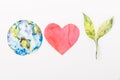 top view of paper made colorful globe, red heart and green plant isolated on grey, recycling and environment protection concept