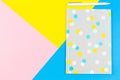 Top view of paper notebook with pen on blue, yellow and pink background. Royalty Free Stock Photo