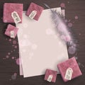 Top view of paper sheet with feather and pink gift box with tags and bokeh on wood background concept. Empty and blank space for