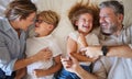 Top view, parents and children on bed relax, fun and laugh together on weekend. Family, love and happy man and woman in Royalty Free Stock Photo